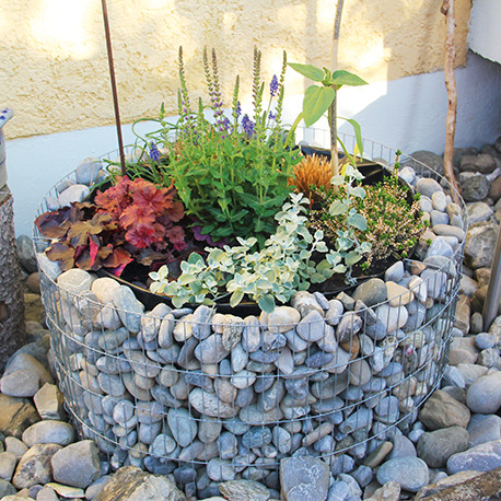 Jardinière en acier ronde gabion 81 x 81 x 40 cm avec galets Jardinière en acier ronde gabion 81 x 81 x 40 cm avec galets